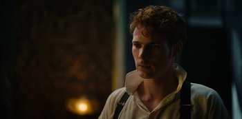 Movie still from “The Empress” (2022), created by Katharina Eyssen – A man with a beard is standing in a room; Close Up shot, Over the shoulder angle