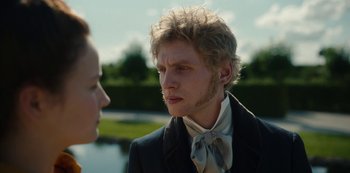 Movie still from “The Empress” (2022), created by Katharina Eyssen – A man in a suit and a woman in a white shirt; Close Up shot, Over the shoulder angle