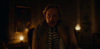 Movie still from “The Empress” (2022), created by Katharina Eyssen – A man with a beard and a fur coat; Medium shot, Over the shoulder angle