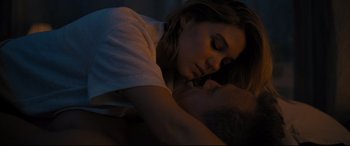 Movie still from “No Time to Die” (2021), directed by Cary Joji Fukunaga – A woman is sleeping with her head on a mans chest; Close Up shot, Overhead angle