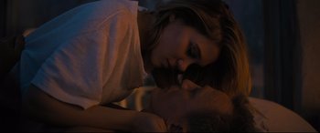 Movie still from “No Time to Die” (2021), directed by Cary Joji Fukunaga – A man and a woman laying on a bed; Close Up shot, Low angle