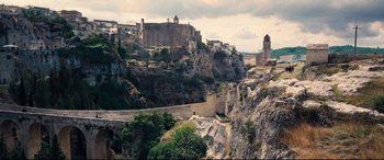 Movie still from “No Time to Die” (2021), directed by Cary Joji Fukunaga – A view of a city from a cliff; Extreme Wide shot, Low angle