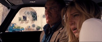 Movie still from “No Time to Die” (2021), directed by Cary Joji Fukunaga – A man and a woman in the back seat of a car; Close Up shot, Over the shoulder angle