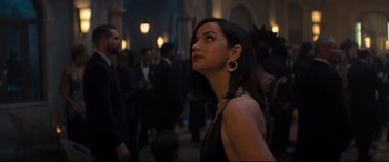 Movie still from “No Time to Die” (2021), directed by Cary Joji Fukunaga – A woman standing in front of a group of people; Close Up shot, Over the shoulder angle