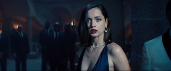 Movie still from “No Time to Die” (2021), directed by Cary Joji Fukunaga – A woman in a blue dress and a diamond necklace; Close Up shot, Over the shoulder angle