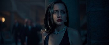 Movie still from “No Time to Die” (2021), directed by Cary Joji Fukunaga – A beautiful woman with dark hair wearing a black dress; Close Up shot, Low angle