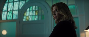 Movie still from “No Time to Die” (2021), directed by Cary Joji Fukunaga – A woman standing in front of a stained glass window; Medium shot, Low angle