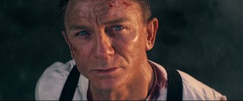 Movie still from “No Time to Die” (2021), directed by Cary Joji Fukunaga – A person with a scar on his face; Close Up shot, Over the shoulder angle