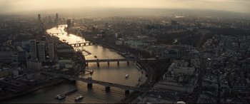 Movie still from “No Time to Die” (2021), directed by Cary Joji Fukunaga – An aerial view of a river and a city; Extreme Wide shot, High angle