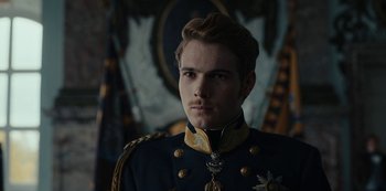Movie still from “The Empress” (2022), created by Katharina Eyssen – A man in a military uniform is looking at the camera; Close Up shot, Low angle