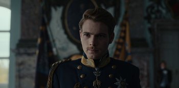 Movie still from “The Empress” (2022), created by Katharina Eyssen – A man in a military uniform is looking at the camera; Close Up shot, Over the shoulder angle