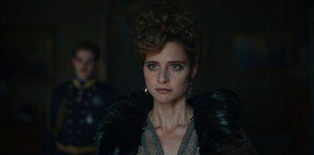 Movie still from “The Empress” (2022), created by Katharina Eyssen – A person wearing a dress; Close Up shot, Over the shoulder angle