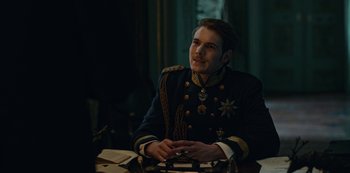 Movie still from “The Empress” (2022), created by Katharina Eyssen – A man in a military uniform sitting at a table; Medium shot, Over the shoulder angle