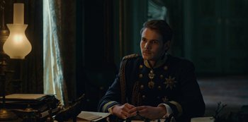 Movie still from “The Empress” (2022), created by Katharina Eyssen – A man in a military uniform sitting at a table; Medium shot, Over the shoulder angle