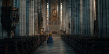 Movie still from “The Empress” (2022), created by Katharina Eyssen – A woman dressed in medieval clothing in a cathedral; Extreme Wide shot, Low angle
