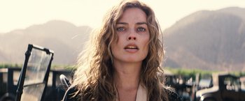 Movie still from “Babylon” (2022), directed by Damien Chazelle – A person with long curly hair; Close Up shot, Low angle