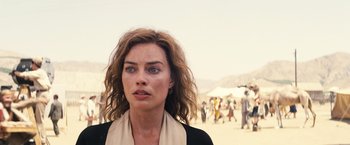 Movie still from “Babylon” (2022), directed by Damien Chazelle – A person wearing a black shirt; Close Up shot, Over the shoulder angle