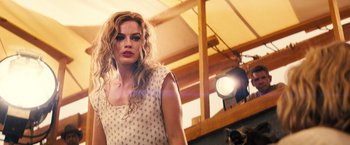 Movie still from “Babylon” (2022), directed by Damien Chazelle – A woman standing in front of a camera; Close Up shot, Low angle