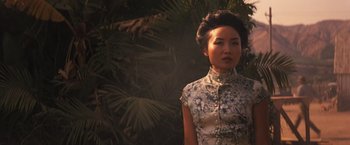 Movie still from “Babylon” (2022), directed by Damien Chazelle – A woman standing in front of a tree; Medium shot, Low angle