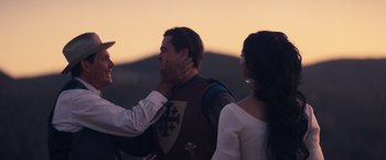 Movie still from “Babylon” (2022), directed by Damien Chazelle – A man in a knight's costume is touching the face of a woman; Close Up shot, Over the shoulder angle