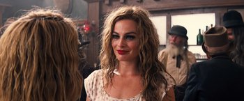 Movie still from “Babylon” (2022), directed by Damien Chazelle – A person with long hair; Close Up shot, Over the shoulder angle