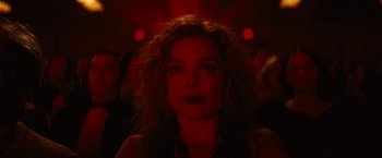 Movie still from “Babylon” (2022), directed by Damien Chazelle – A person in a dark room; Close Up shot, Low angle