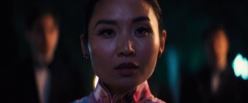Movie still from “Babylon” (2022), directed by Damien Chazelle – A woman's face in front of a dark background; Close Up shot, Low angle