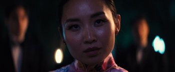 Movie still from “Babylon” (2022), directed by Damien Chazelle – A woman's face in front of a dark background; Close Up shot, Low angle