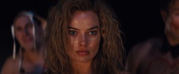 Movie still from “Babylon” (2022), directed by Damien Chazelle – A person with long curly hair; Close Up shot, Low angle