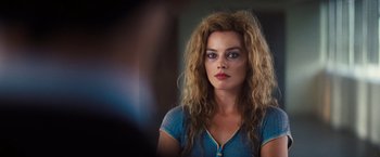 Movie still from “Babylon” (2022), directed by Damien Chazelle – A person with long curly hair; Close Up shot, Over the shoulder angle