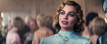 Movie still from “Babylon” (2022), directed by Damien Chazelle – A person wearing a necklace; Close Up shot, Over the shoulder angle