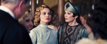 Movie still from “Babylon” (2022), directed by Damien Chazelle – Two women standing next to each other in front of a crowd; Close Up shot, Low angle