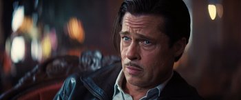 Movie still from “Babylon” (2022), directed by Damien Chazelle – A person wearing a leather jacket; Close Up shot, Over the shoulder angle