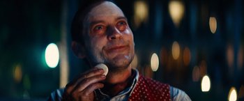 Movie still from “Babylon” (2022), directed by Damien Chazelle – A person talking on a cell phone; Close Up shot, Low angle