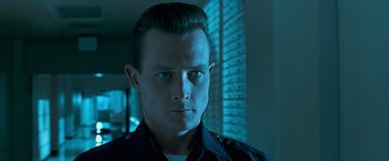 Movie still from “Babylon” (2022), directed by Damien Chazelle – A person wearing a police uniform; Close Up shot, Low angle