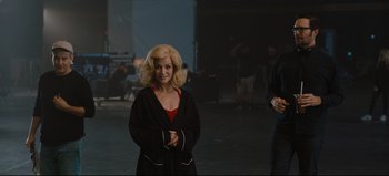 Movie still from “Nope” (2022), directed by Jordan Peele – A woman standing in the middle of a room with her arms crossed; Medium shot, Over the shoulder angle