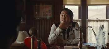 Movie still from “Nope” (2022), directed by Jordan Peele – A man sitting at a table in front of a mirror; Medium shot, Over the shoulder angle