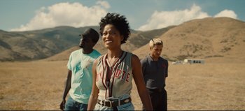 Movie still from “Nope” (2022), directed by Jordan Peele – A group of people standing on top of a dirt hill; Medium shot, Low angle