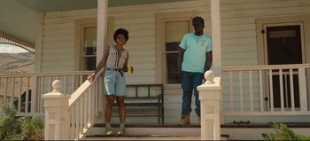 Movie still from “Nope” (2022), directed by Jordan Peele – A man and a woman standing on the steps of a house; Wide shot, Low angle