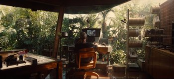 Movie still from “Nope” (2022), directed by Jordan Peele – A man sitting in front of two computer monitors; Wide shot, Over the shoulder angle