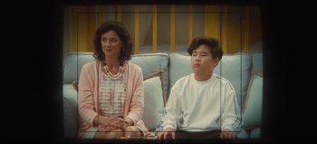 Movie still from “Nope” (2022), directed by Jordan Peele – A woman and a boy sitting on a couch; Medium shot, Over the shoulder angle