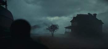 Movie still from “Nope” (2022), directed by Jordan Peele – A tree in front of a house on a cloudy day; Extreme Wide shot, Low angle