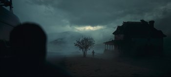 Movie still from “Nope” (2022), directed by Jordan Peele – A person standing in front of a tree in the middle of a field; Extreme Wide shot, Low angle