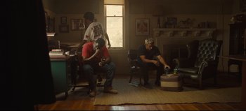 Movie still from “Nope” (2022), directed by Jordan Peele – A group of people sitting in a living room; Wide shot, Low angle