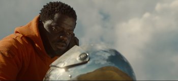 Movie still from “Nope” (2022), directed by Jordan Peele – A person with a helmet on; Close Up shot, Over the shoulder angle