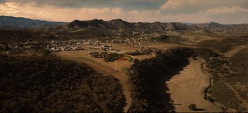 Movie still from “Nope” (2022), directed by Jordan Peele – An aerial view of a rural area with mountains in the background; Extreme Wide shot, High angle