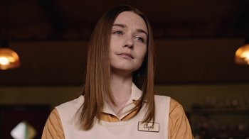 Movie still from “The End of the F***ing World” (2017), directed by Jonathan Entwistle – A woman with long brown hair and a name tag on her shirt; Close Up shot, Over the shoulder angle