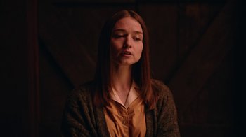 Movie still from “The End of the F***ing World” (2017), directed by Jonathan Entwistle – A woman with long brown hair wearing an orange shirt; Medium shot, Over the shoulder angle