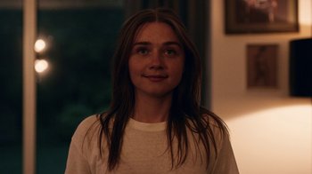 Movie still from “The End of the F***ing World” (2017), directed by Jonathan Entwistle – A woman with long brown hair wearing a white t - shirt; Close Up shot, Over the shoulder angle