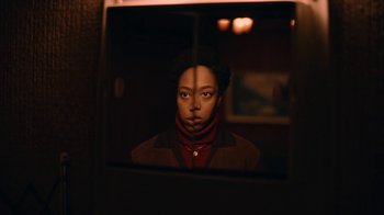 Movie still from “The End of the F***ing World” (2017), directed by Jonathan Entwistle – A woman looking into a mirror in a dark room; Medium shot, Low angle